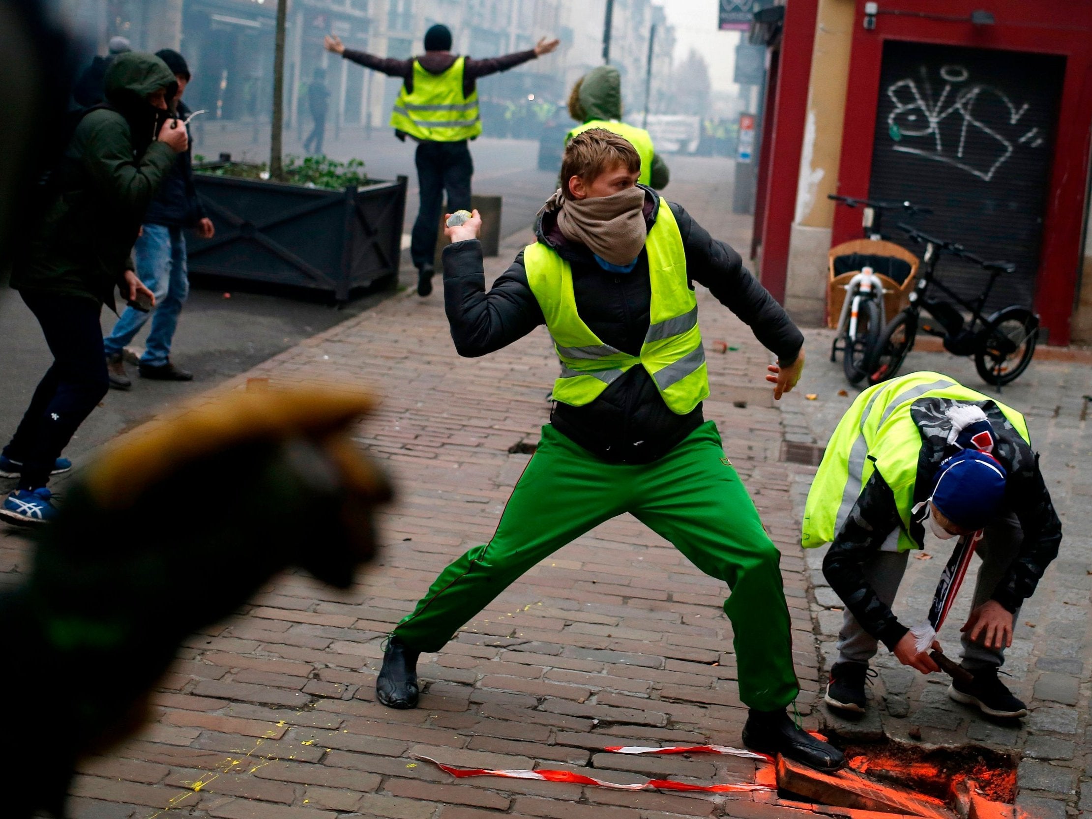 Anti-government protesters throw stones on a street in Rouen (AFP/Getty)