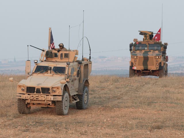 US and Turkish troops conduct a convoy during joint patrol in Syria in November