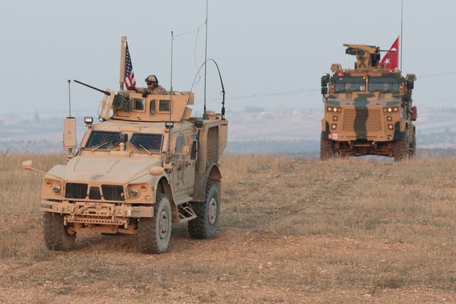 US and Turkish troops conduct a convoy during joint patrol in Syria in November