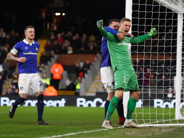 Daniel Ivarsen celebrates after saving Aleksandar Mitrovic's penalty effort