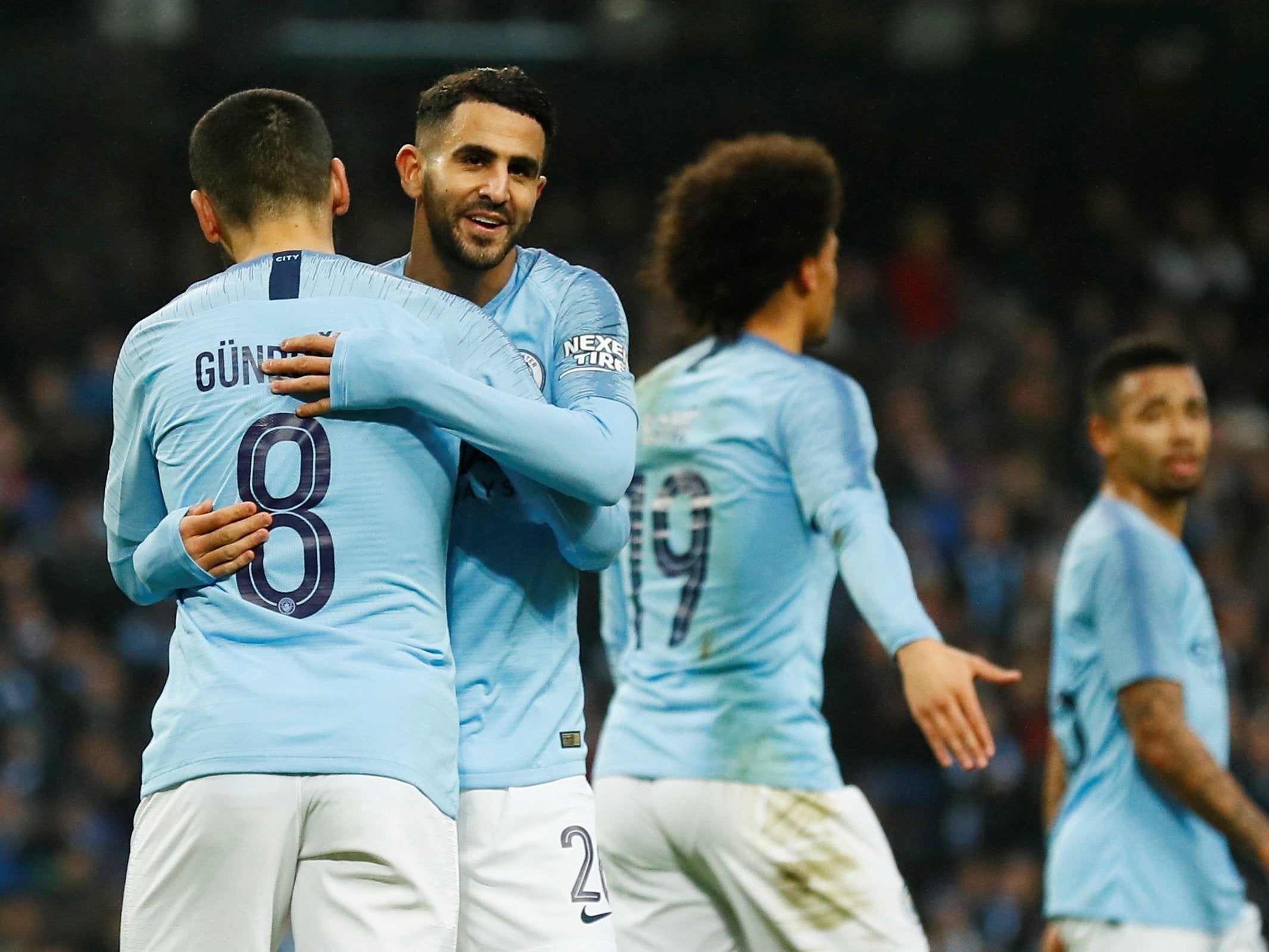 Riyad Mahrez celebrates with Ilkay Gundogan after adding the fifth