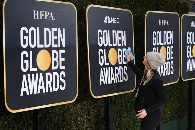 Workers and staff prepare the red carpet area for the 76th Golden Globe Awards