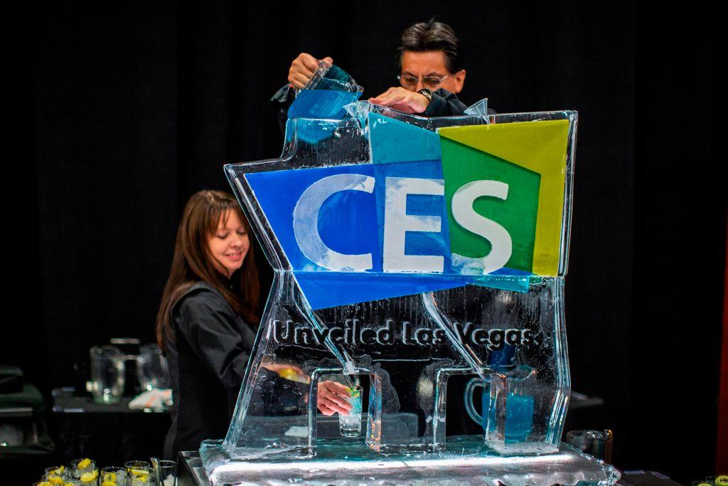Workers serve beverages from an ice sculpture during CES 2019 in Las Vegas, Nevada, on January 6, 2018