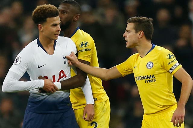 Tottenham Hotspur's Dele Alli is held back by Chelsea's Cesar Azpilicueta