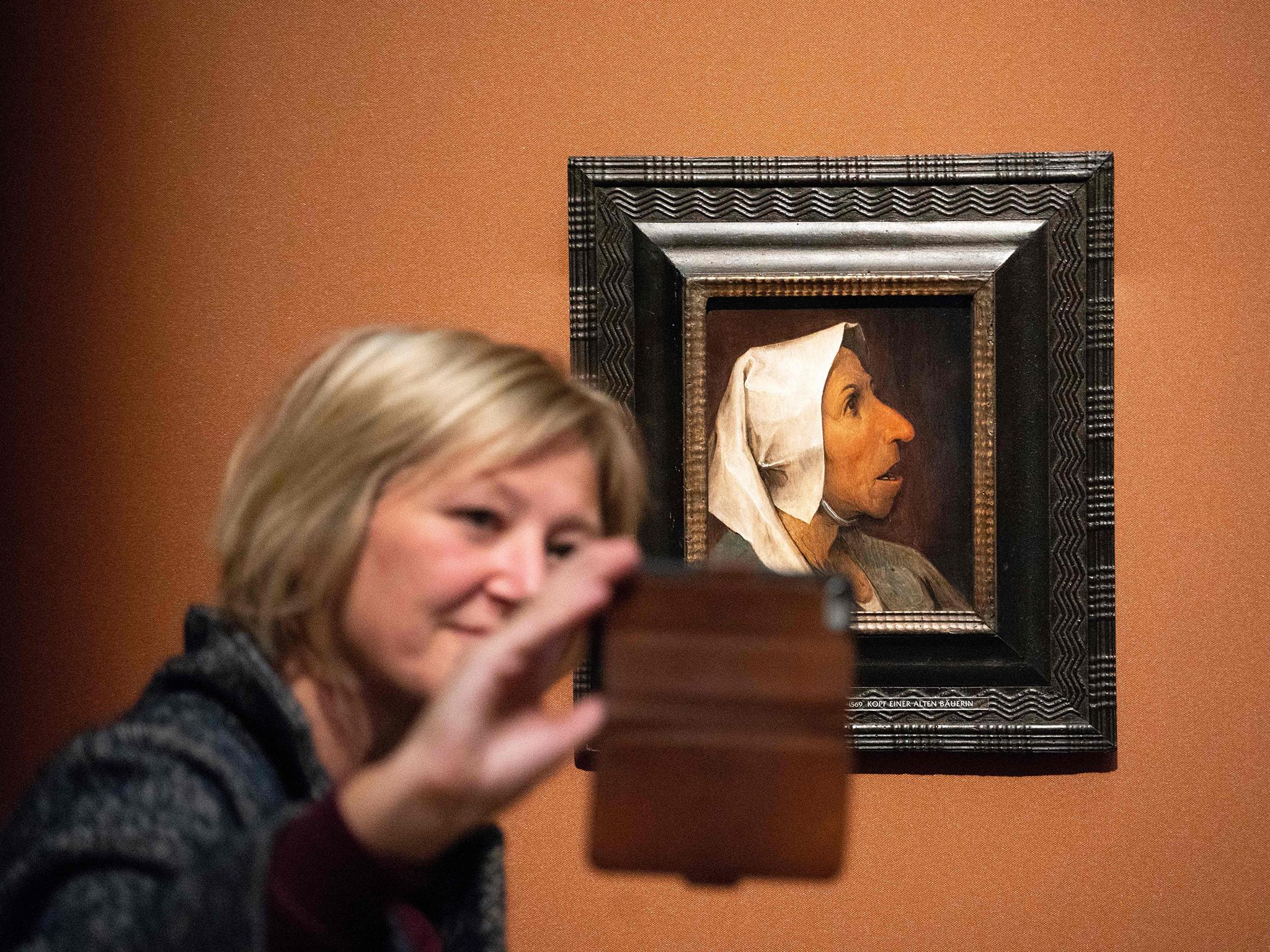 A visitor takes a selfie with Pieter Bruegel the Elder's ‘Head of a Peasant Woman’ at the Kunsthistorisches Museum in Vienna
