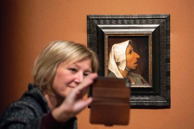 A visitor takes a selfie with Pieter Bruegel the Elder's ‘Head of a Peasant Woman’ at the Kunsthistorisches Museum in Vienna