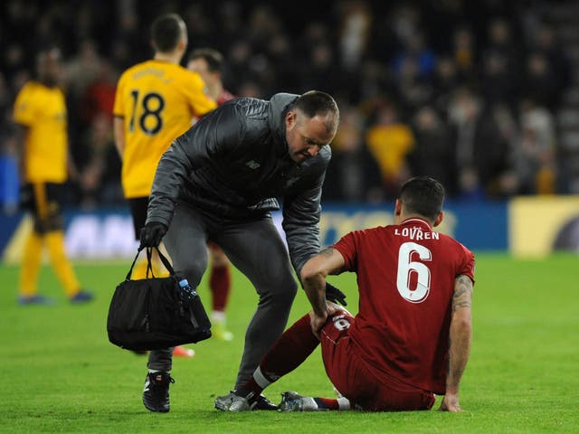 Liverpool's Dejan Lovren is treated after he is injured