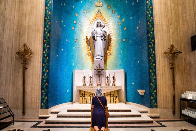 A visitor prays inside the Basilica of the National Shrine of the Immaculate Conception, the largest Catholic church in the United States
