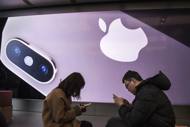 Customers gather as they take part in a class to learn how to use their iPhones at an Apple Store on January 7, 2019 in Beijing, China