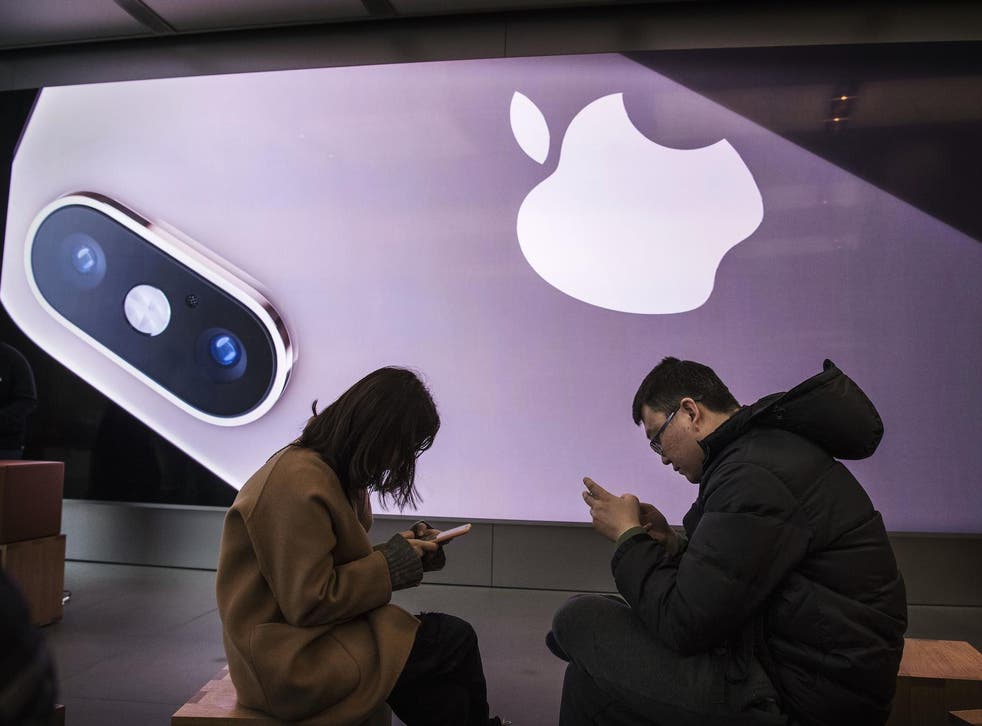 Customers gather as they take part in a class to learn how to use their iPhones at an Apple Store on January 7, 2019 in Beijing, China