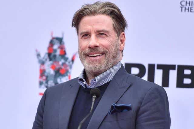 John Travolta attends the Hand And Footprint Ceremony Honoring Pitbull at TCL Chinese Theatre on 14 December, 2018 in Hollywood, California.