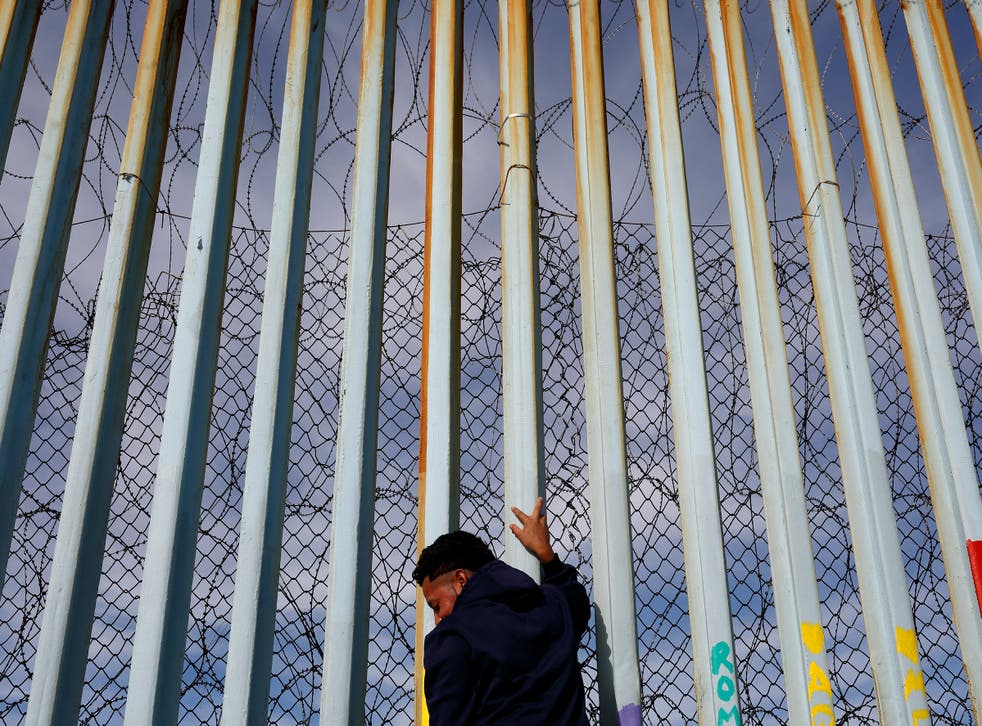 A barbed wire border wall in Tijuana, Mexico