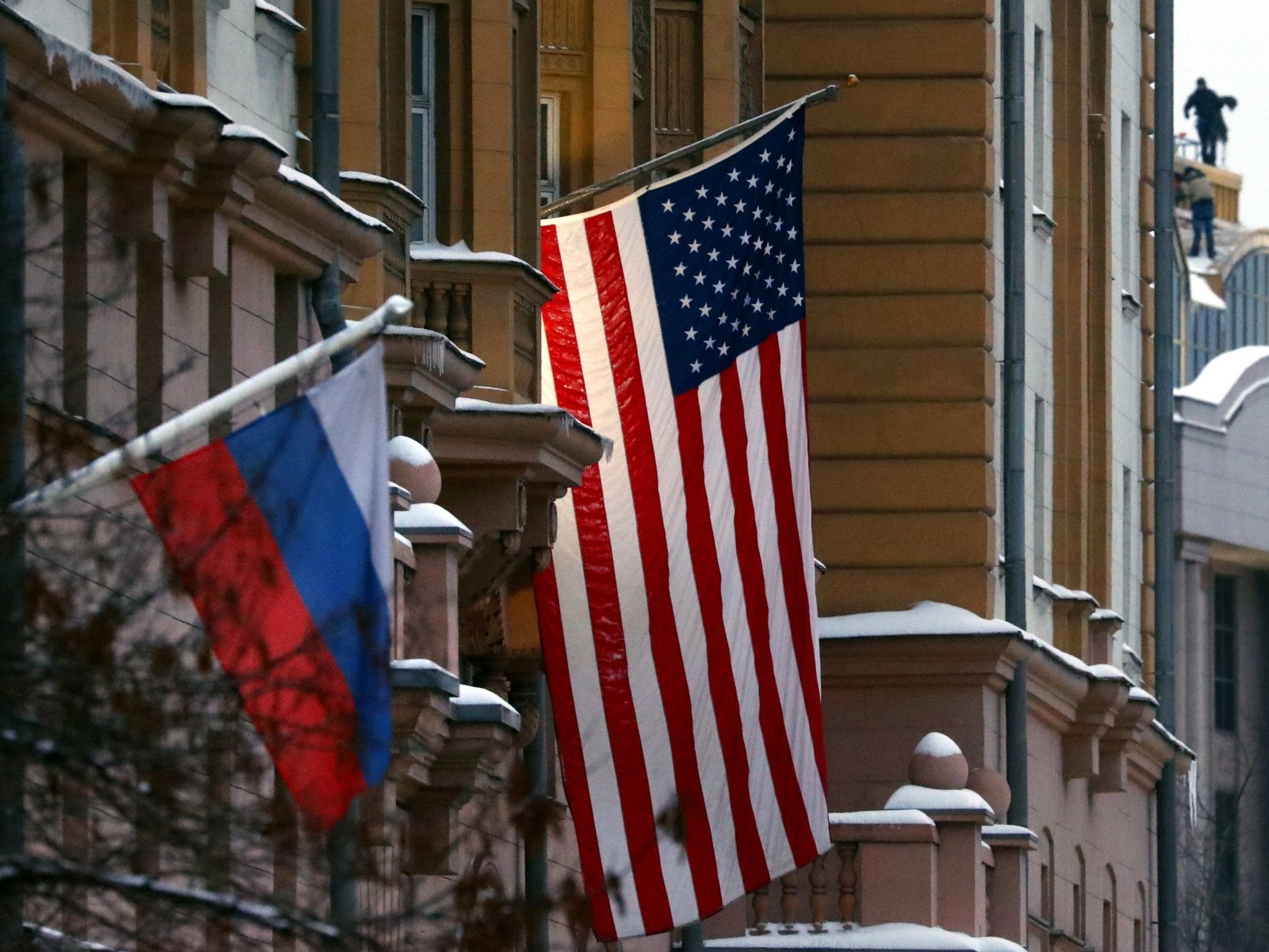 A Russian flag flies next to the US embassy building in Moscow, Russia