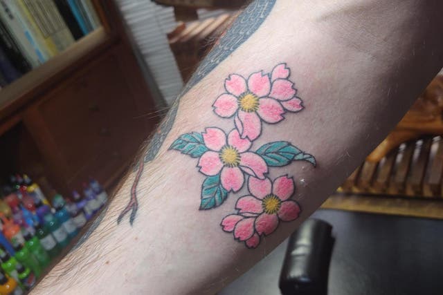 Andrew Dickens got a sakura tattooed on his forearm