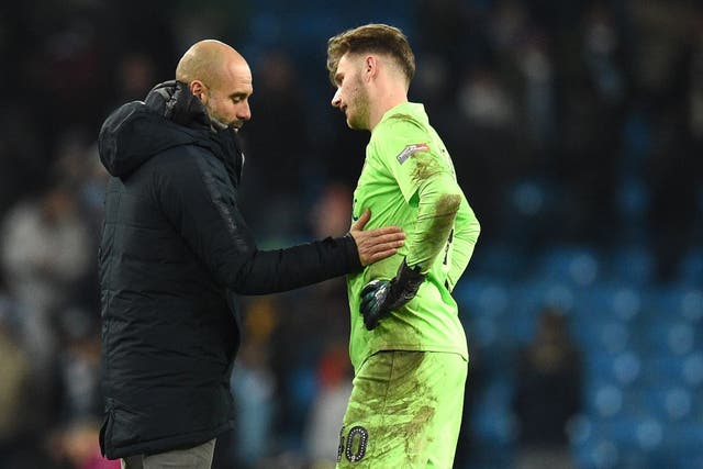 Pep Guardiola commiserates with Burton Albion goalkeeper Bradley Collins after Manchester City's 9-0 victory