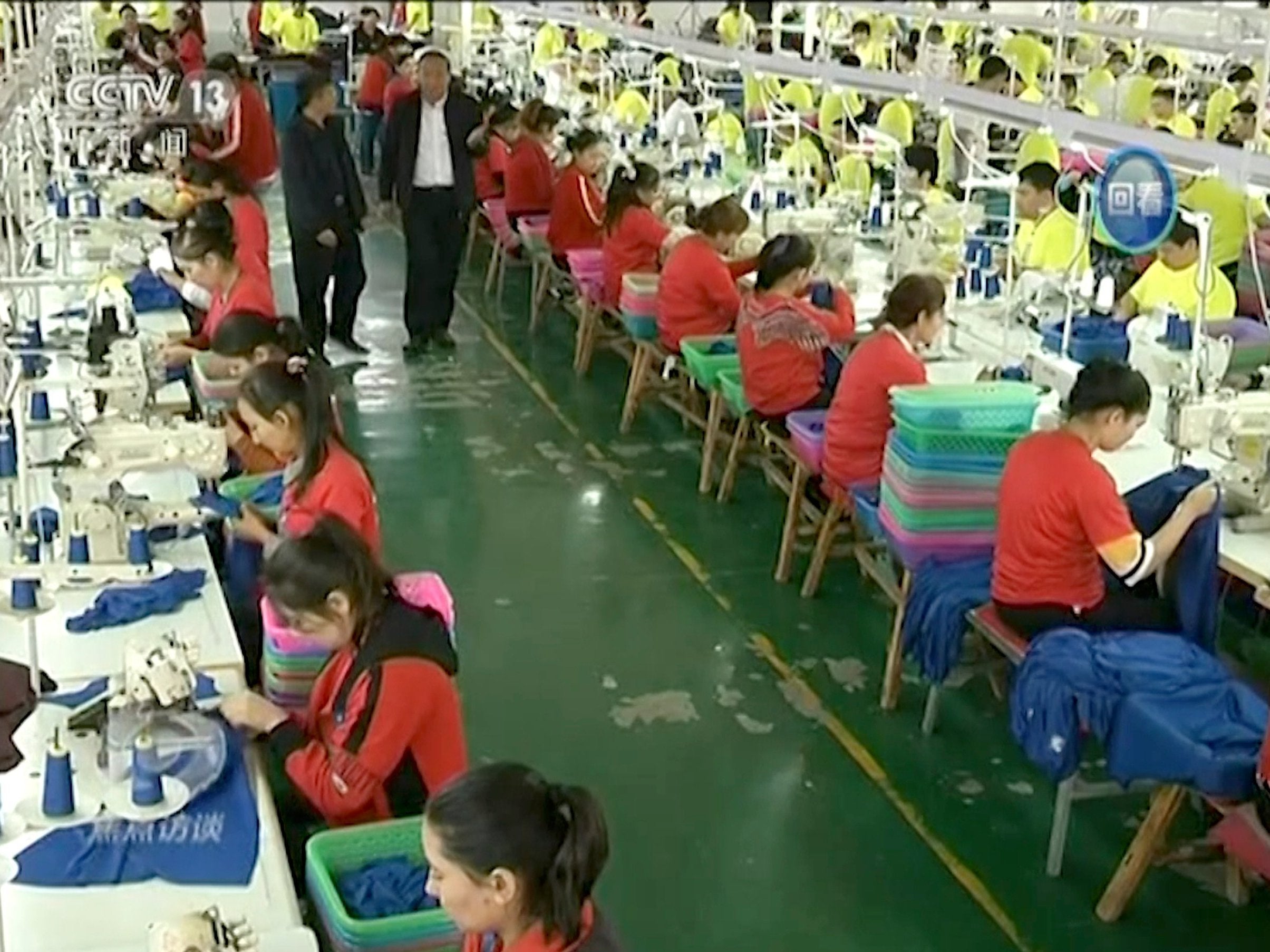 Chinese television footage shows Muslim workers at a clothing factory at an internment camp in Hotan, Xinjiang