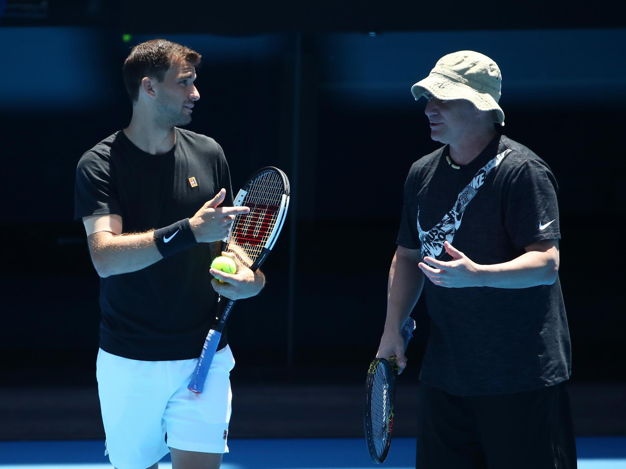 Grigor Dimitrov talks with his coach Andre Agassi