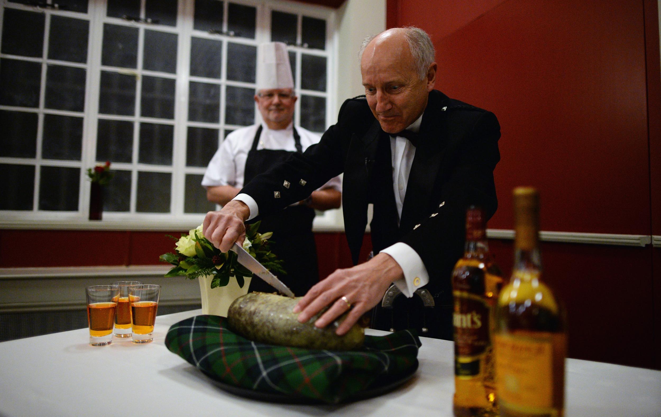 Cutting the haggis at Burns Night celebrations in Alloway, where the poet was born (Jeff J Mitchell/Getty)