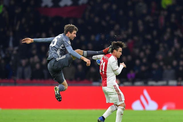 Thomas Mueller kicks Ajax's defender Nicolas Tagliafico
