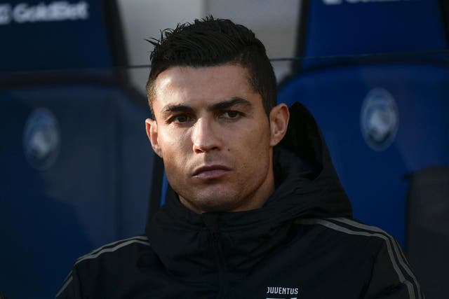 Juventus' Cristiano Ronaldo looks on from the substitutes' bench
