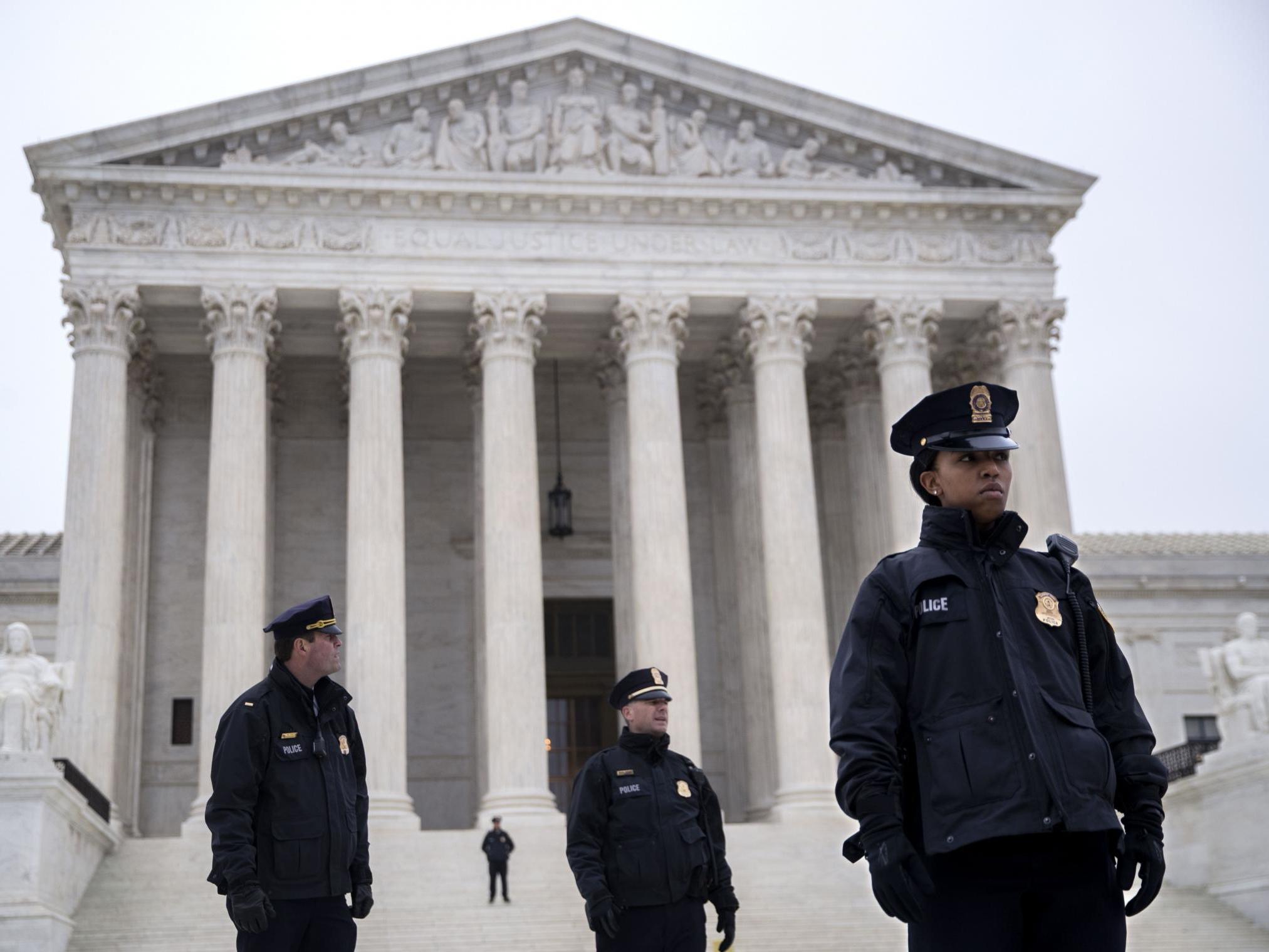 Police officers standing outside the Supreme Court, where free speech has been defended as a constitutional right
