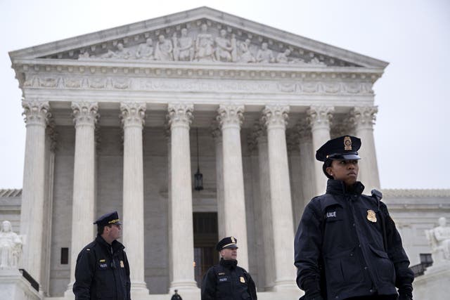 Police officers standing outside the Supreme Court, where free speech has been defended as a constitutional right