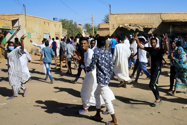 Demonstrators march along the street during anti-government rallies after Friday prayers in Khartoum