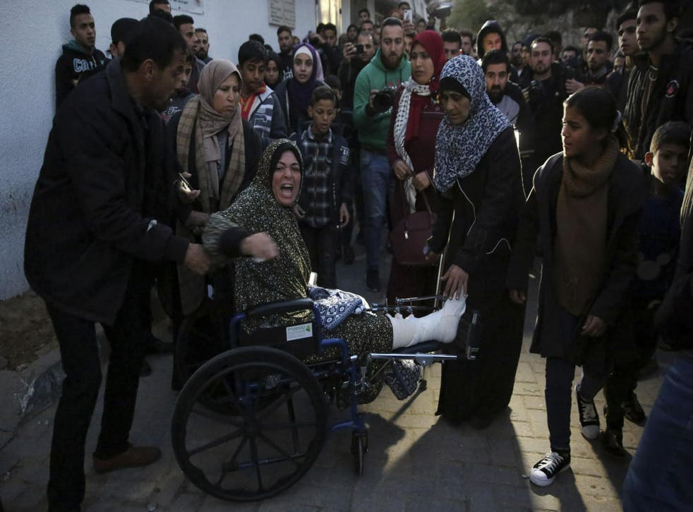 Relatives arrives to the morgue of Shifa hospital to see the body of a woman who was killed by Israeli troops during a protest at the Gaza Strip's border with Israel, in Gaza City, Friday