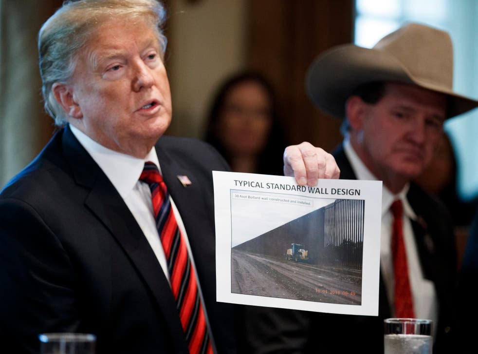 President Donald Trump presents a 'typical standard wall design' as he participates in a round-table discussion on border security