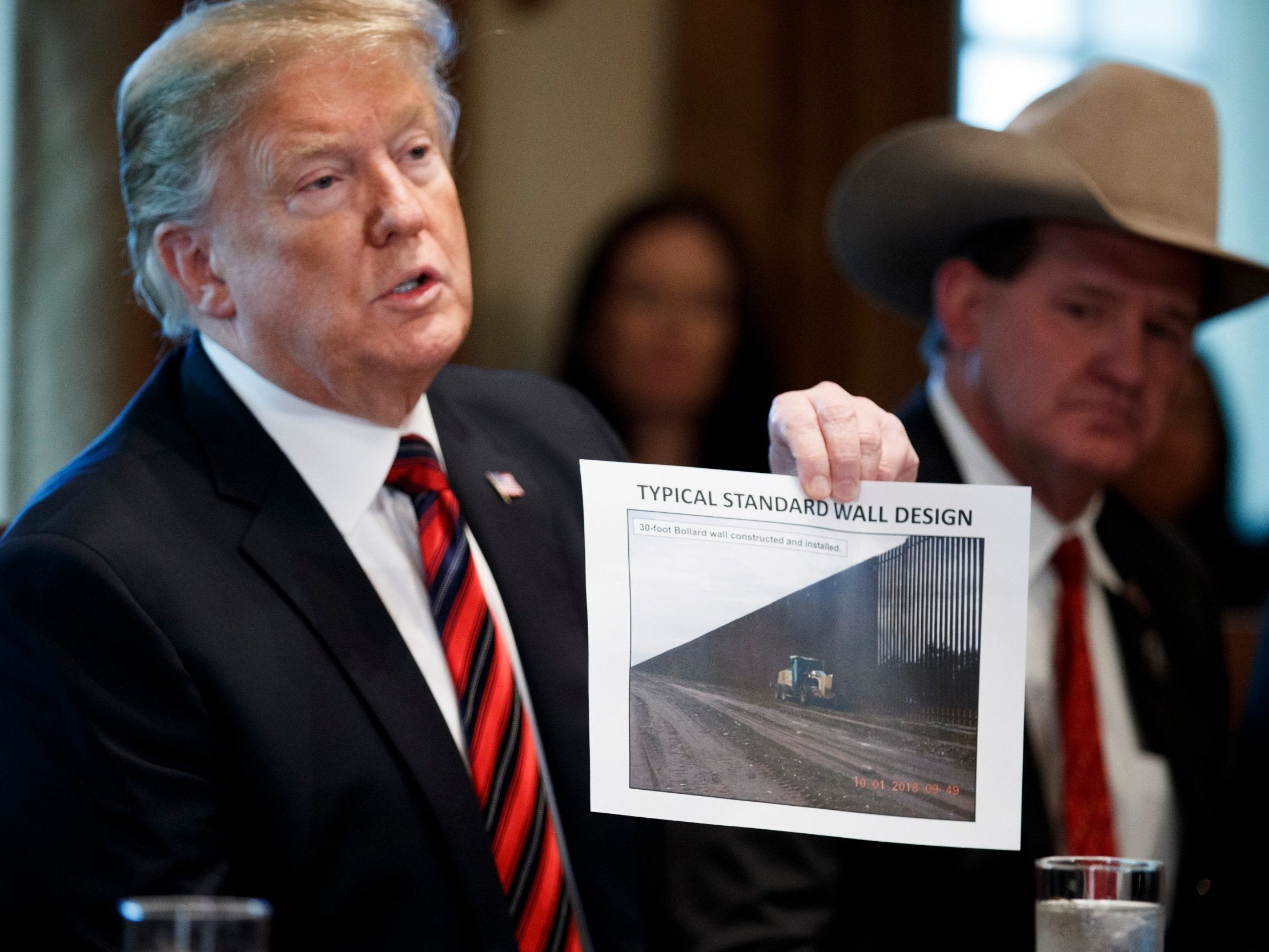 Donald Trump shows an image of the wall design during a White House meeting on Friday