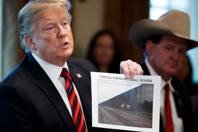 Donald Trump shows an image of the wall design during a White House meeting on Friday