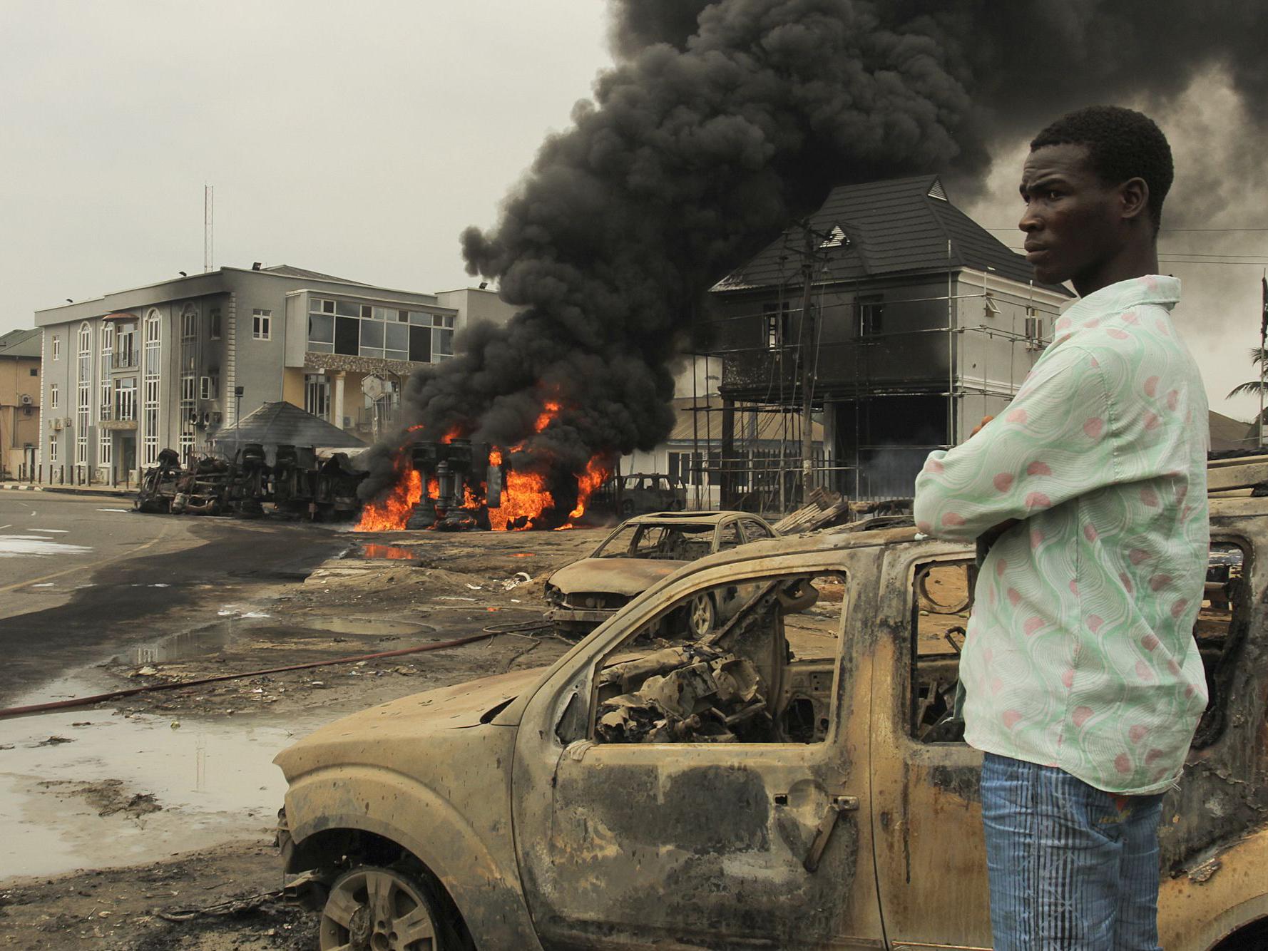A Nigerian man looks over the scene at an oil tanker explosion in 2015