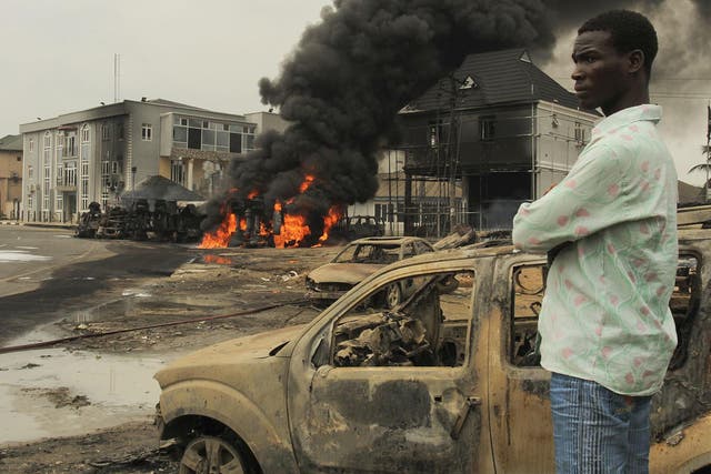 A Nigerian man looks over the scene at an oil tanker explosion in 2015