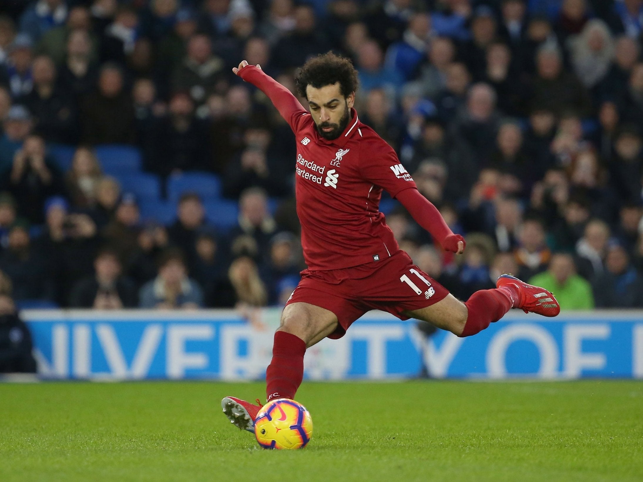 Mohamed Salah strikes his penalty effort as he scores for Liverpool