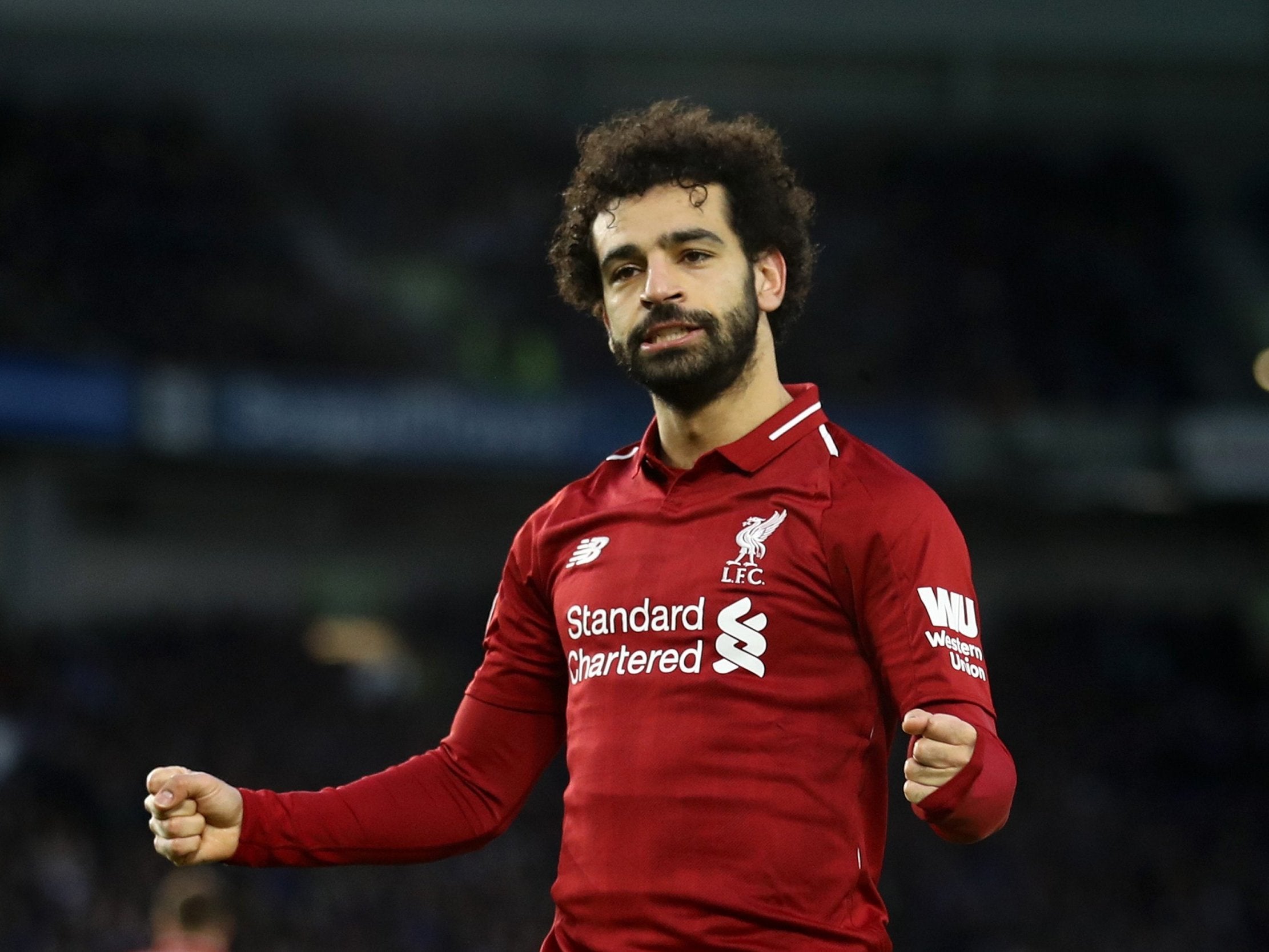 Mohamed Salah celebrates after scoring for Liverpool from the penalty spot against Brighton