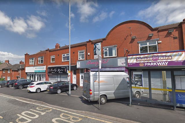Armed robbers burst into the café on Princess Road in the Moss Side area of Manchester