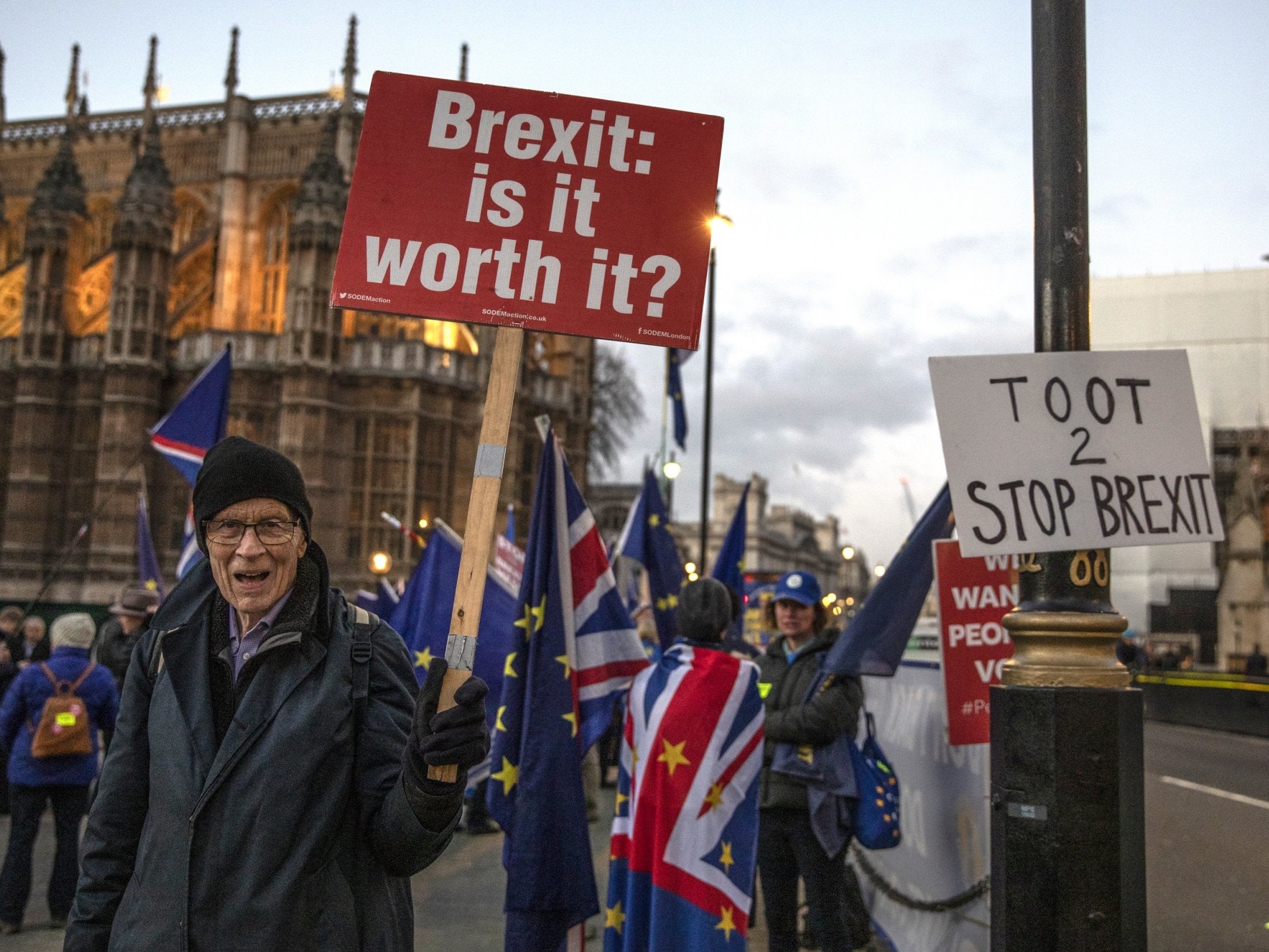 Campaigners outside the Houses of Parliament as MPs prepare for Tuesday's crucial vote on the Brexit deal