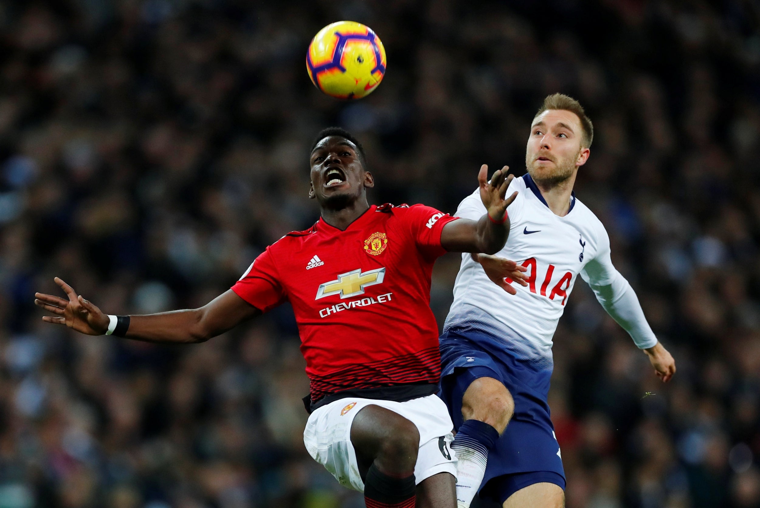 Paul Pogba and Christian Eriksen tussle for possession