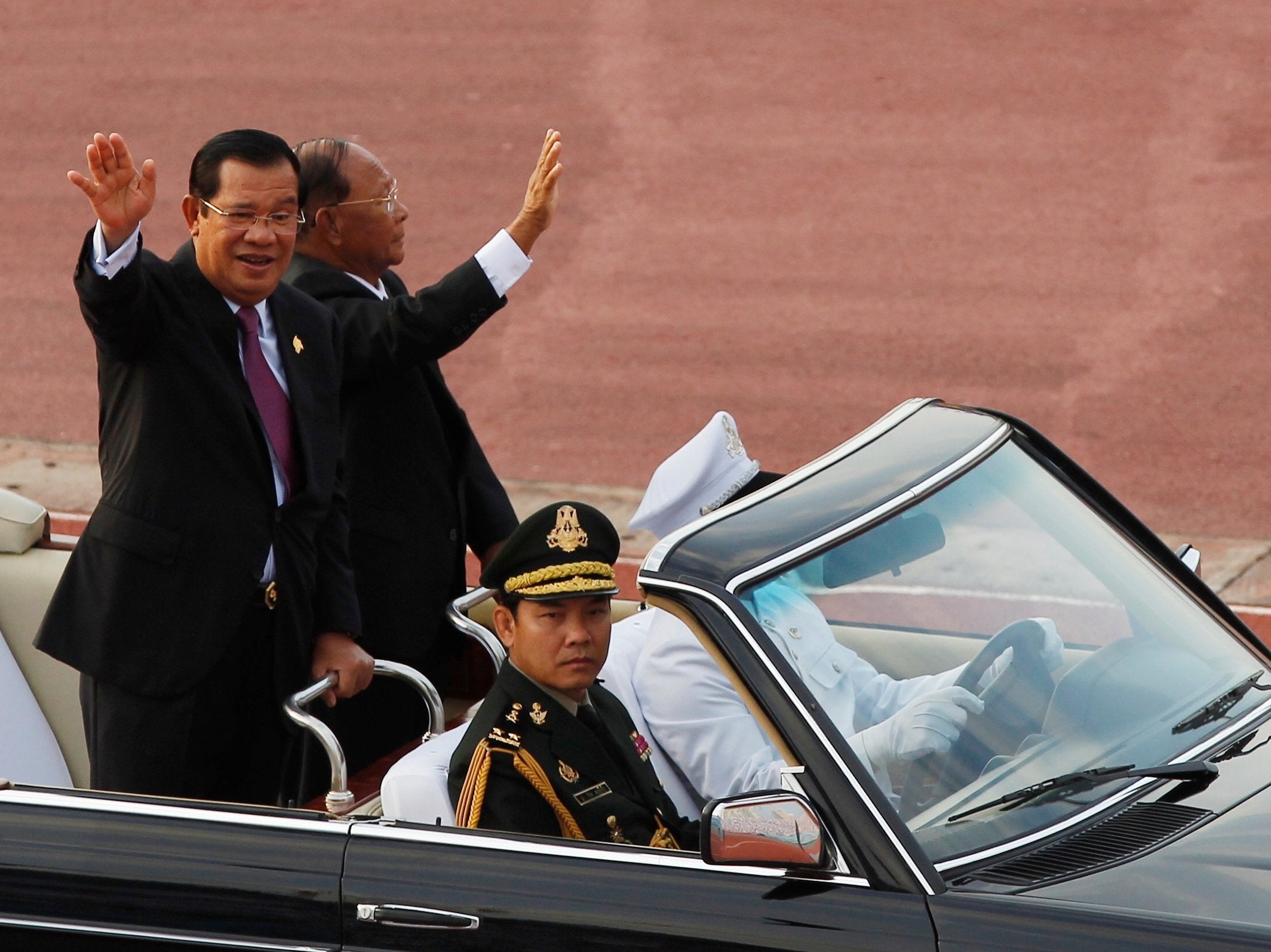 PM Hun Sen, left waves to government civil servants with his National Assembly President Heng Sermin during the country's 40th anniversary of the Victory Over Genocide Day at National Olympic Stadium,Phnom Penh, Cambodia, on Monday 7 January 2019