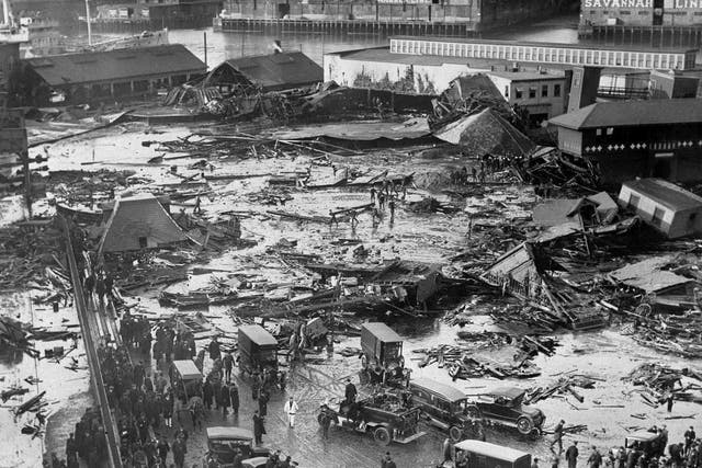 In this 15 January 1919 file photo, the ruins of tanks containing more than two million gallons of molasses lie in a heap after erupting along the waterfront in Boston's North End neighbourhood. Several buildings were flattened in the disaster, which killed 21 people and injured 150 others.