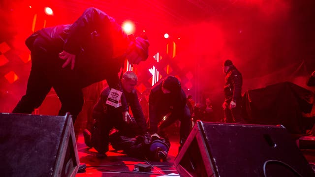 Security staff trying to stop a man after he attacked Mayor of Gdansk, Pawel Adamowicz, during the 27th finale of the Great Orchestra of Christmas Charity in Poland