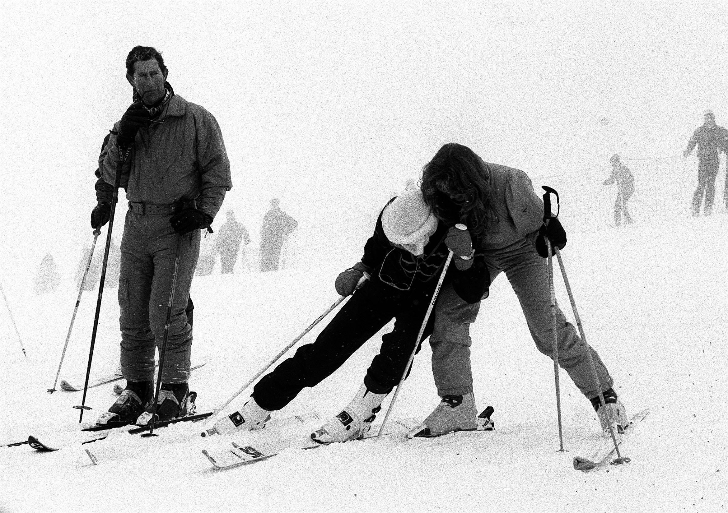 February 1987: Charles watches sisters-in-law Di and Fergie larking about on the slopes of chic winter resort Klosters, in the Swiss Alps