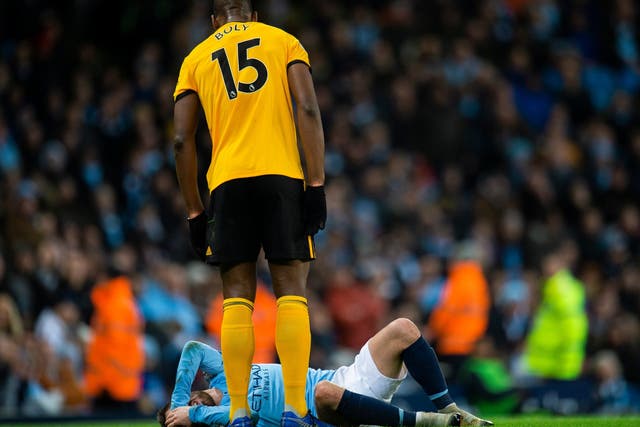 Wolverhampton Wanderers Willy Boly stands over Manchester City's Bernardo Silva