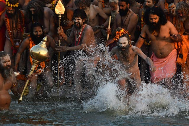 Indian sadhus take a dip at the holy Sangam – the confluence of the Ganges, Yamuna and mythical Saraswati rivers