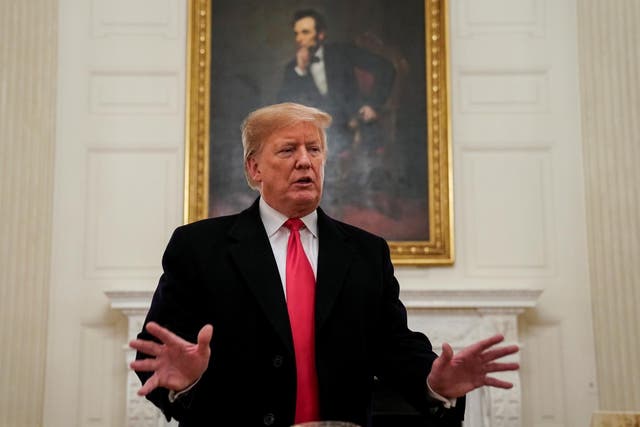 Donald Trump speaks in front of a portrait of Abraham Lincoln before welcoming the 2018 College Football Playoff National Champion Clemson Tigers in the State Dining Room of the White House