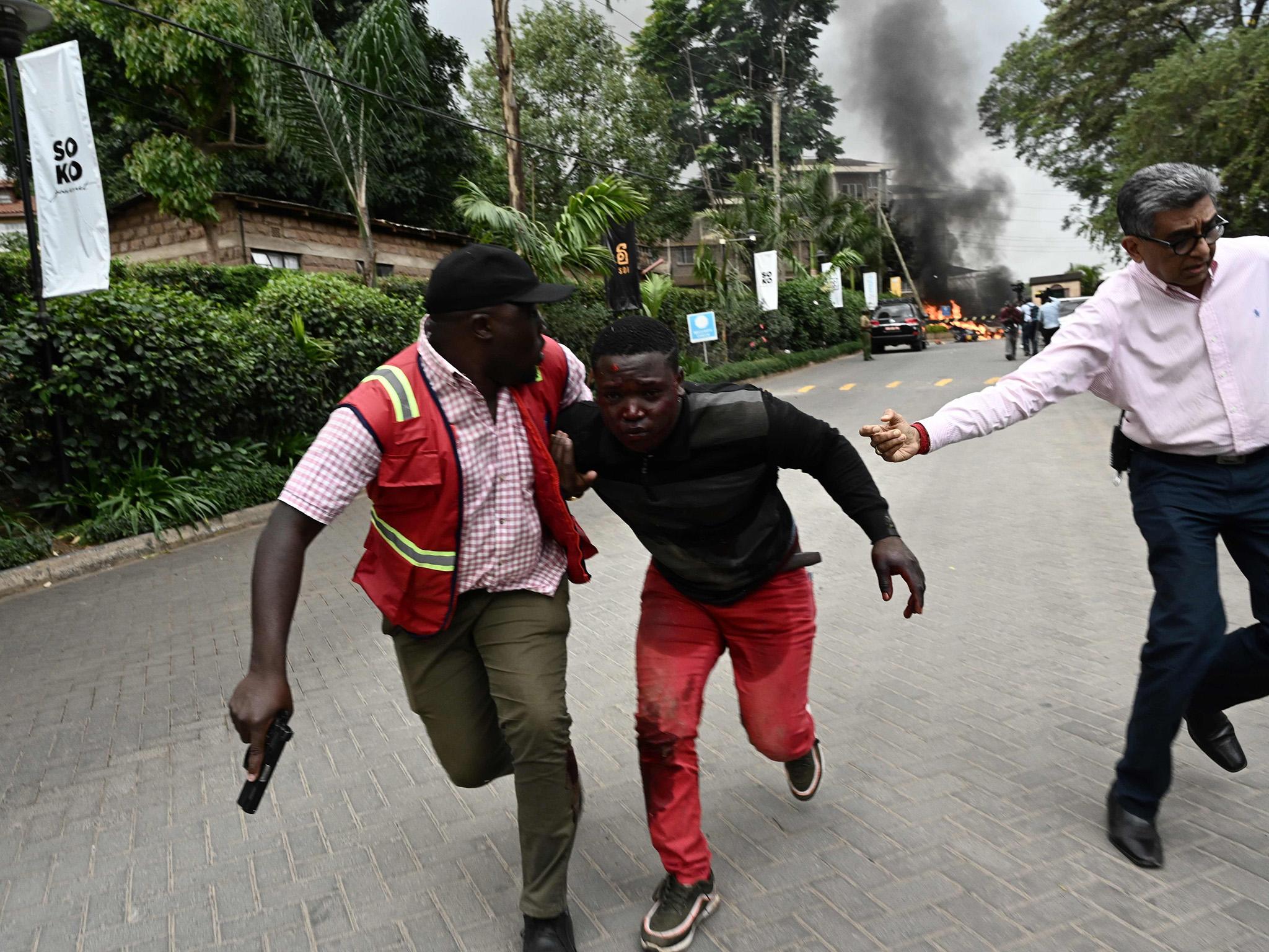 An injured man is taken from the scene