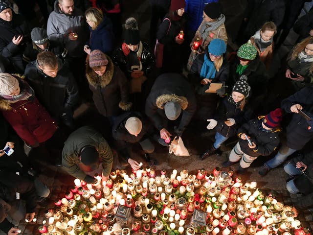 Candles are lit at the Golden Gate in Gdansk where Pawel Adamowicz was stabbed
