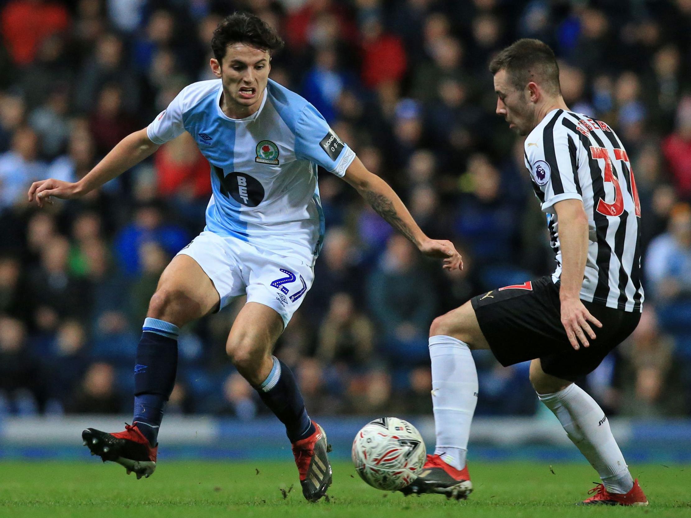 Lewis Travis battles with Callum Roberts for possession