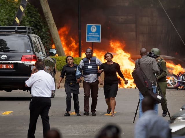 Security forces help civilians flee the scene at hotel complex in Nairobi