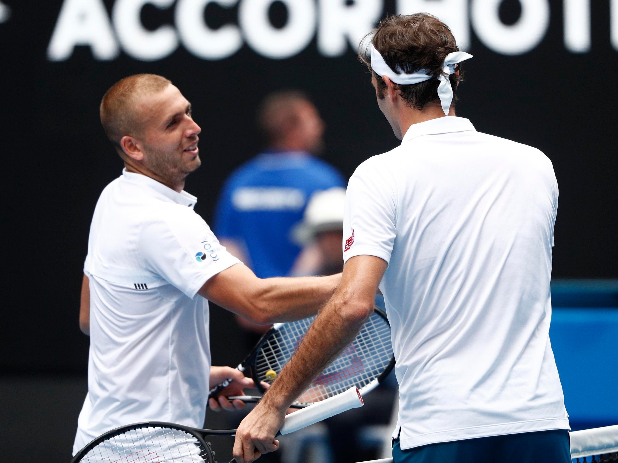 Dan Evans congratulates Roger Federer after their Australian Open second round match